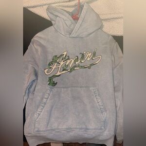 AMIRI Sky Blue Hoodie with Leafy Green Design